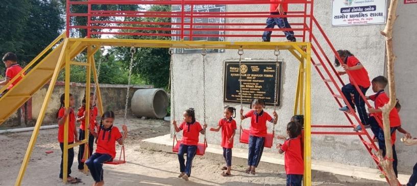 Children enjoying the newly installed swings and slide at Samor school
