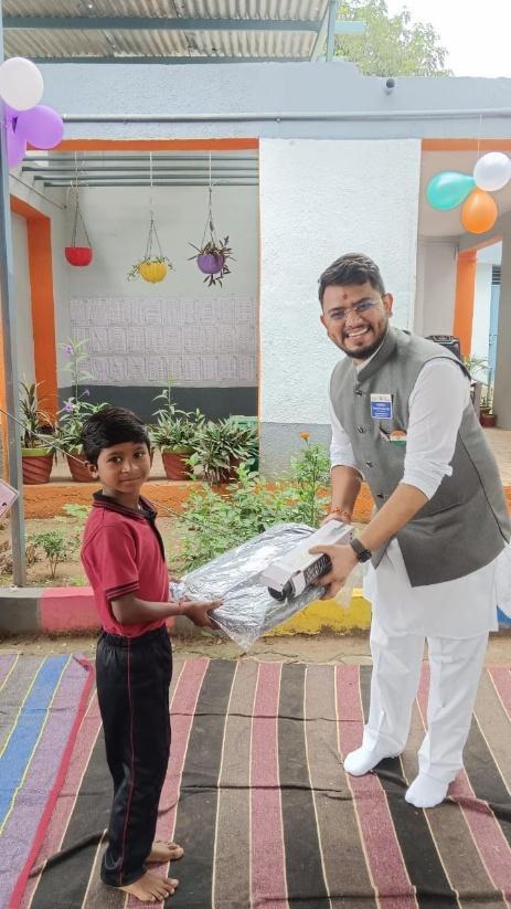 Handing over backpacks and water filtration bags to student